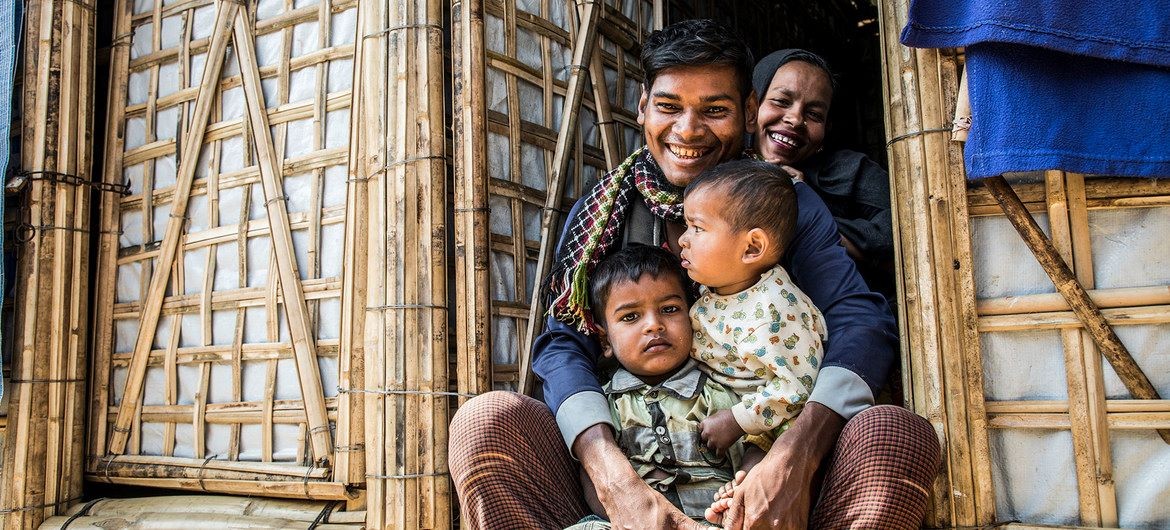 A Rohingya refugee family sit in the doorway of their new monsoon-ready shelter in Cox’s Bazar, Bangladesh.