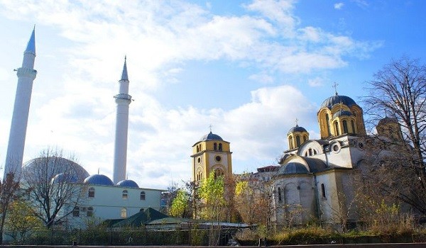 Church and Mosque in the same garden in Kosovo